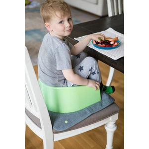 PeapodMats washable, reusable waterproof 1.5'x1.5' chair pad for bed wetting and incontinence, product illustration in dark grey with toddler; mat protects seat during meals