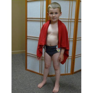 Child wearing SOSecure Containment Swim Brief for Children worn as is with fun pattern on velcro tab closures